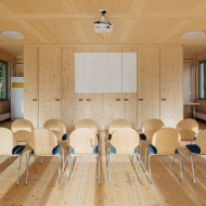 Interior of the Sportfeld pavilion with wooden chairs