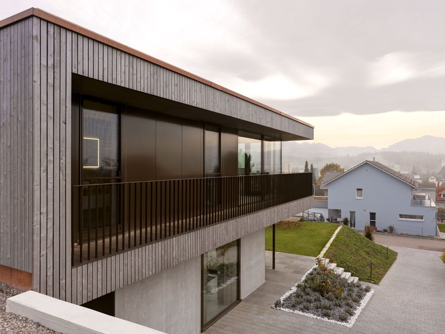 Side view of the detached house with striking timber facade