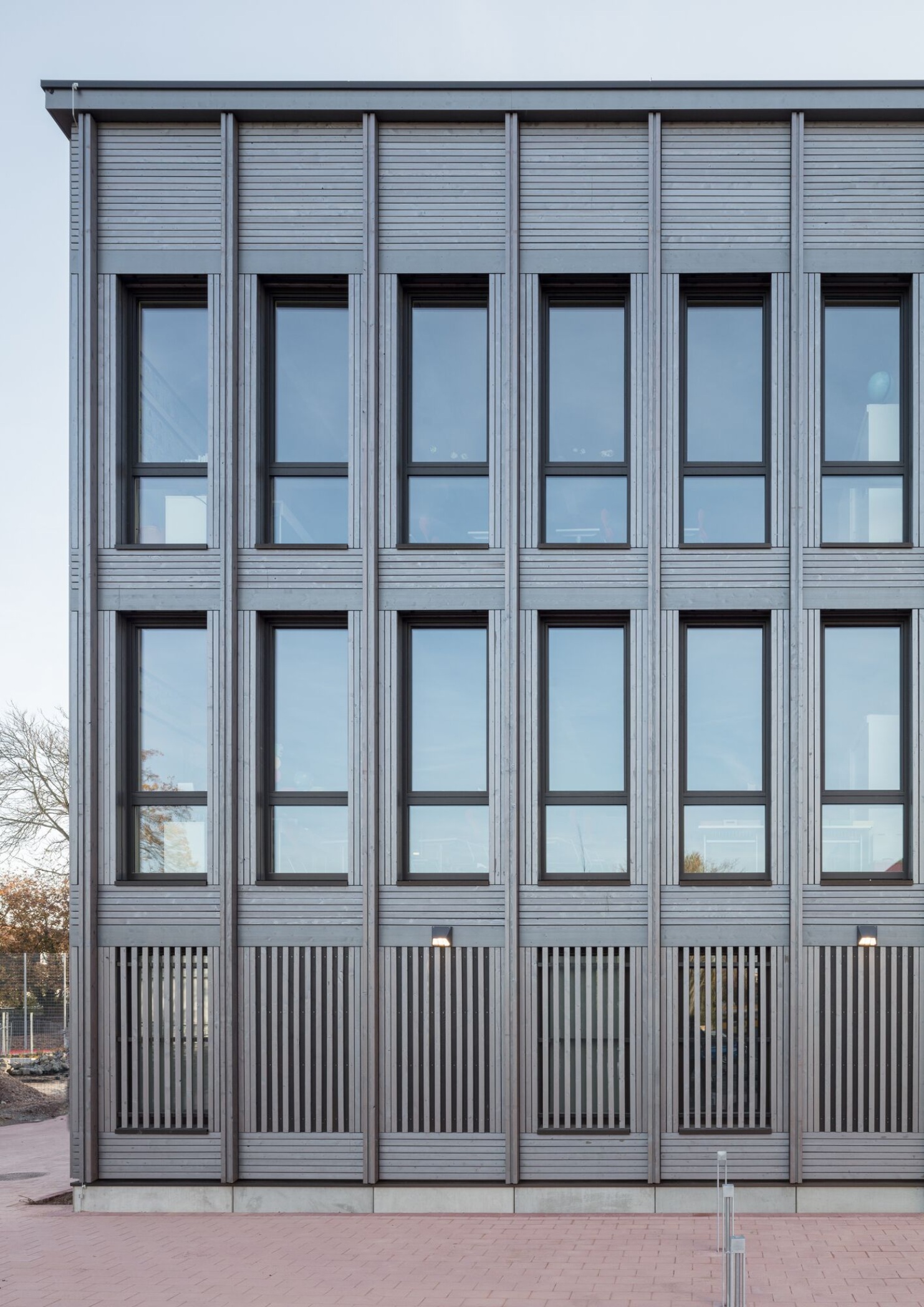 Facade of the school building in modular timber construction 
