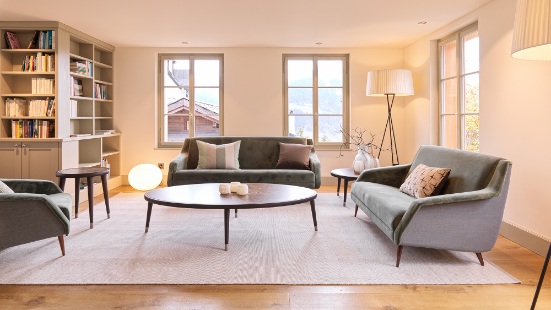 Light-filled lounge in the new extension wing at Lampart’s Val Lumnezia.