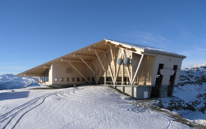 East view of Chäserrugg summit restaurant in Toggenburg in the snow with blue sky