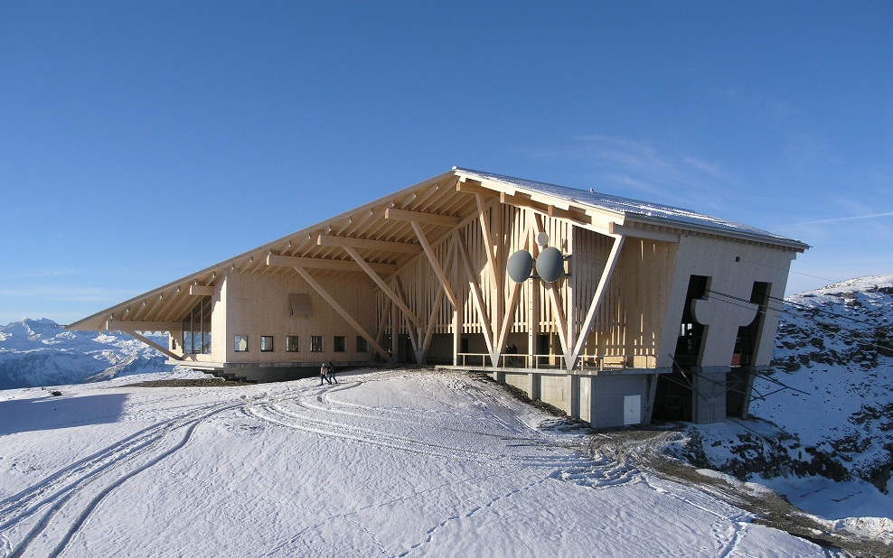 East view of Chäserrugg summit restaurant in Toggenburg in the snow with blue sky